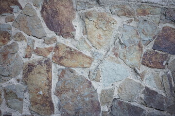 Textured stone wall showcasing natural colors and patterns in daylight