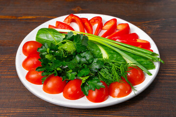 Fresh vegetable platter with colorful ingredients on a wooden table Savory vegetable pie served with fresh garnishes