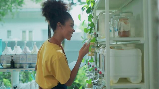 Female customer fills cereal foods in a glass jar, lever the reusable container on refill store shelves, zero-waste and plastic-free grocery, environment-friendly, sustainable lifestyles.