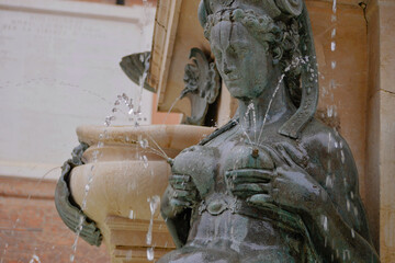 A sculpture of lactating Nereid as a part of The Fountain of Neptune in Bologna, Italy