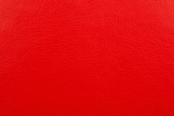 Texture of colored leather. Background made of genuine red leather. Material