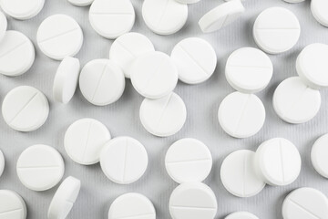 Many antibiotic pills on grey background, closeup
