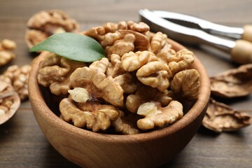 Peeled walnuts in bowl on table, closeup