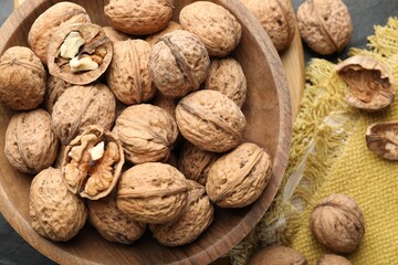 Fresh walnuts in shells on table, flat lay