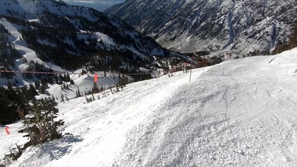 Active Skier Enthusiastically Descending A Snow-covered Mountain Slope With Speed