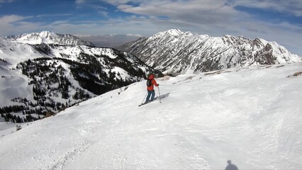An Adventurous Individual Skiing Down A Snow-covered Mountain During Winter Season