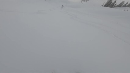 Thrilling Action Shot Of An Adventurous Person Expertly Skiing Down A Beautiful Snowy Slope