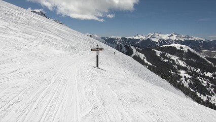 Adventurous Skier Glides Down A Snow-covered Mountain Slope Under Clear Sky