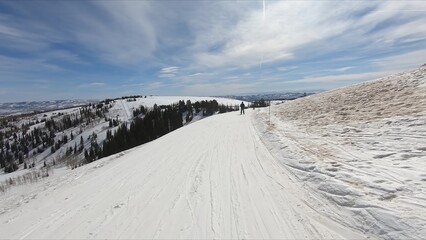 Thrilling Action Shot Of Skier Descending Rapidly On A Hill Covered In Fresh Snow