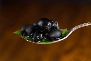black olives in a spoon