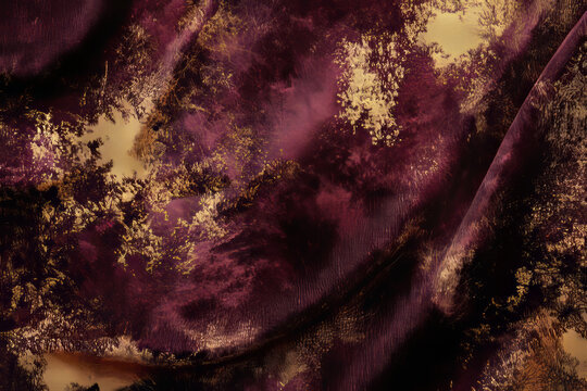 Abstract design with luxurious velvet textures in rich burgundy and gold tones, evoking opulence and elegance.