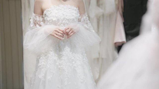 Close up beauty young adult happy woman asia people prepare lace clothes for tied knot wedding life event party get dressed up wear white dress try on fitting room modern luxury bridal store.