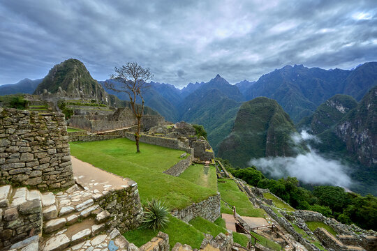 Perched high in the Andes, Machu Picchu stands as a testament to the brilliance of the Inca civilization. Surrounded by misty peaks and lush greenery, this ancient wonder inspires awe and reverence - Powered by Adobe