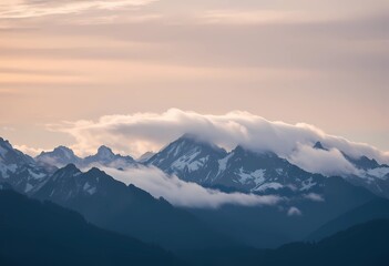 Obraz premium Majestic Mountain Peaks Enveloped in Clouds at Sunset