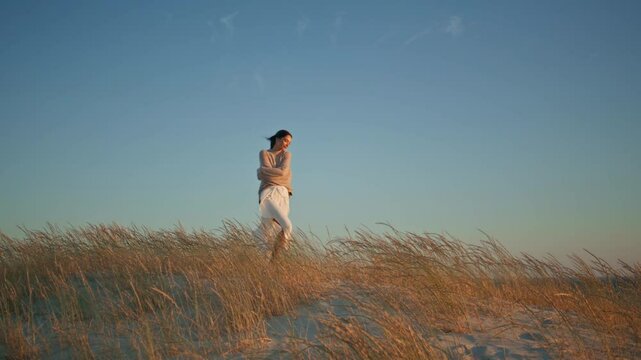 Happy brunette walking sunny nature enjoying summer wind. Young woman spinning