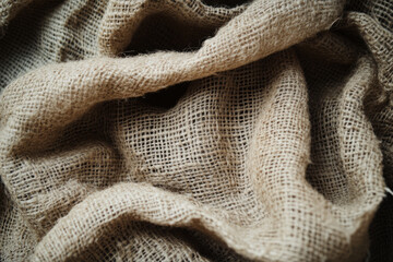 Fototapeta premium Seamless rough burlap fabric, coarse and natural texture with frayed edges, offering an earthy, rustic appeal.