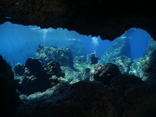 cave diving underwater scuba divers exploring caves, ocean scenery  nice blue light color
