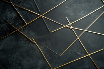 Minimalist thin gold lines, forming intersecting angular shapes on a smooth charcoal background.