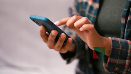 Latin American woman texts tapping smartphone screen