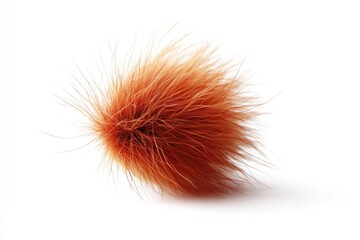A close-up shot of a fluffy furry ball sitting on a white surface
