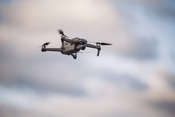 Drone soaring above the treetops during a tranquil sunset ,  navigates the skies with a drone on a calm evening