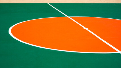 Renovate painting outdoor futsal court with orange circle center and white line on green concrete...
