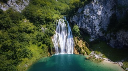 Fototapeta premium Plitvice Lakes National Park: Majestic Waterfall and Turquoise Lake Scenery