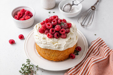 Homemade classic victoria vanilla sponge cake or biscuit or pie decorated with whipped cream and fresh strawberries on top on a light background. Summer dessert. Copy space. Selective focus.