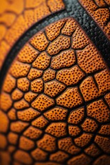 Close-up of an orange basketball's textured surface, showcasing its detailed pattern and grain.