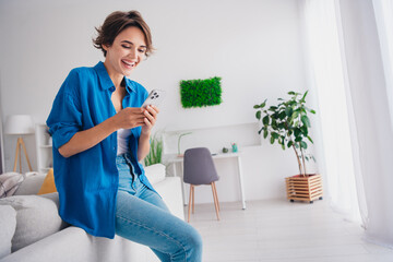 Profile portrait of positive nice lady sit sofa use smart phone laugh typing blog post spacious...