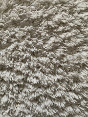 Soft white shaggy carpet texture with deep fibers, creating a cozy and plush surface for interior decor