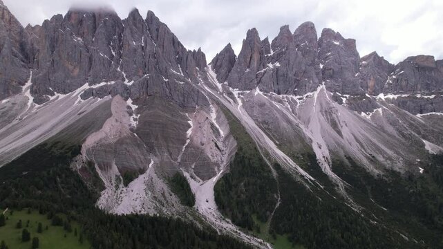 DRONE AERIAL FOOTAGE - The Odle Group is an impressive mountain range in the Dolomites, Bolzano, Trentino Alto Adige, Italy. The main peak of this massif is Mt. Sass Rigais.