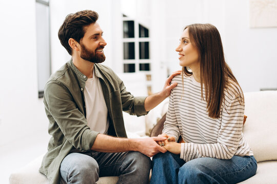 Psychologist comforting patient during therapy session on sofa - Powered by Adobe
