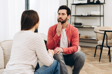 Young couple having a serious conversation at home