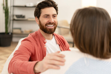 Smiling psychologist comforting patient during therapy session