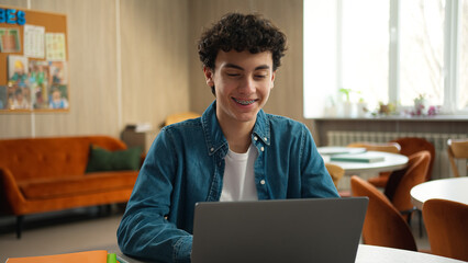 Smiling Caucasian man male teenage happy guy student schoolboy pupil modern technology service...