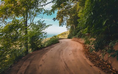 A photo of a winding road leading up a hill, with a view of the surrounding landscape.