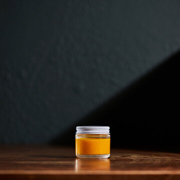 Turmeric and Ginger shots frozen on wooden table and dark background