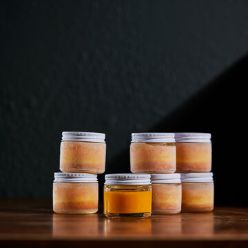 Turmeric and Ginger shots frozen on wooden table and dark background