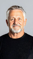 Obraz premium Portrait of mature man, wearing a black shirt, against a neutral background, for marketing purposes