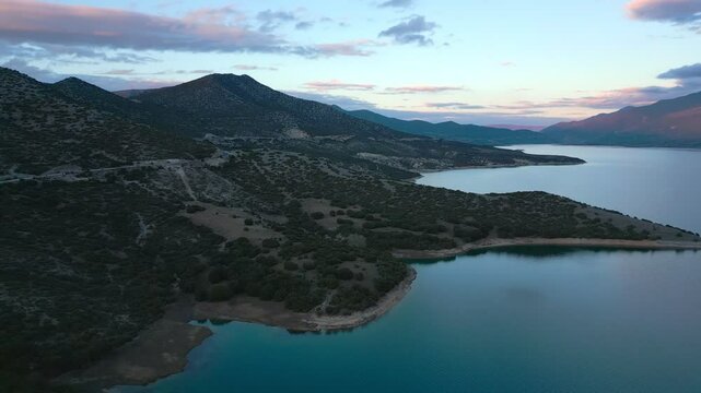 Lake Polyfyto mountain landscape drone aerial view in Greece at sunset