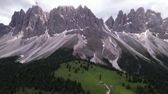 DRONE AERIAL FOOTAGE - The Odle Group is an impressive mountain range in the Dolomites, Bolzano, Trentino Alto Adige, Italy. The main peak of this massif is Mt. Sass Rigais.