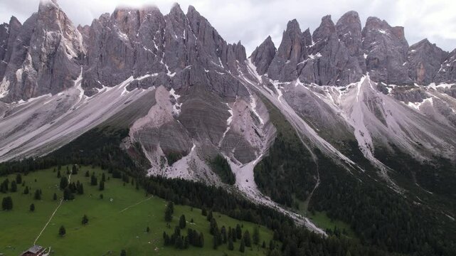 DRONE AERIAL FOOTAGE - The Odle Group is an impressive mountain range in the Dolomites, Bolzano, Trentino Alto Adige, Italy. The main peak of this massif is Mt. Sass Rigais.