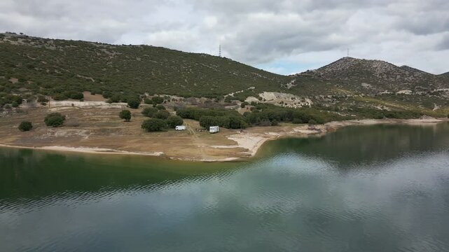 Camper vans parked on a wild spot in Lake Polyfyto drone aerial view in Greece