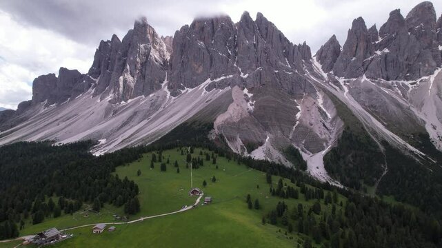 DRONE AERIAL FOOTAGE - The Odle Group is an impressive mountain range in the Dolomites, Bolzano, Trentino Alto Adige, Italy. The main peak of this massif is Mt. Sass Rigais.