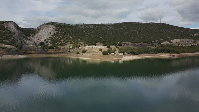 Camper vans parked on a wild spot in Lake Polyfyto drone aerial view in Greece