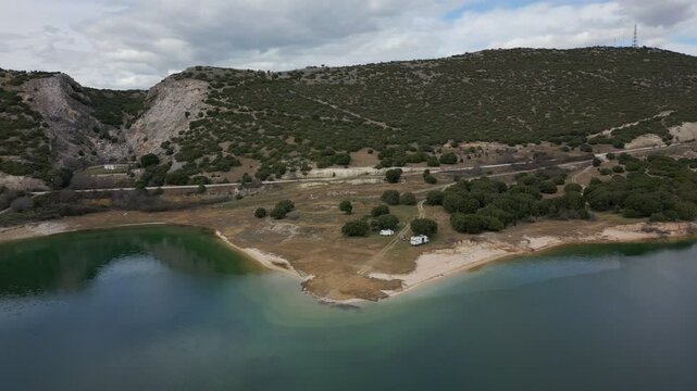 Camper vans parked on a wild spot in Lake Polyfyto drone aerial view in Greece