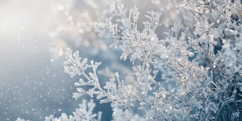 A frosty winter background with delicate silver snowflakes falling against a pale backdrop.