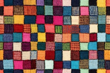 A seamless pattern of colorful fabric squares arranged in an intricate geometric design