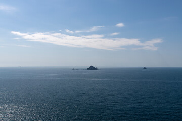 tranquil seascape with boat and rock